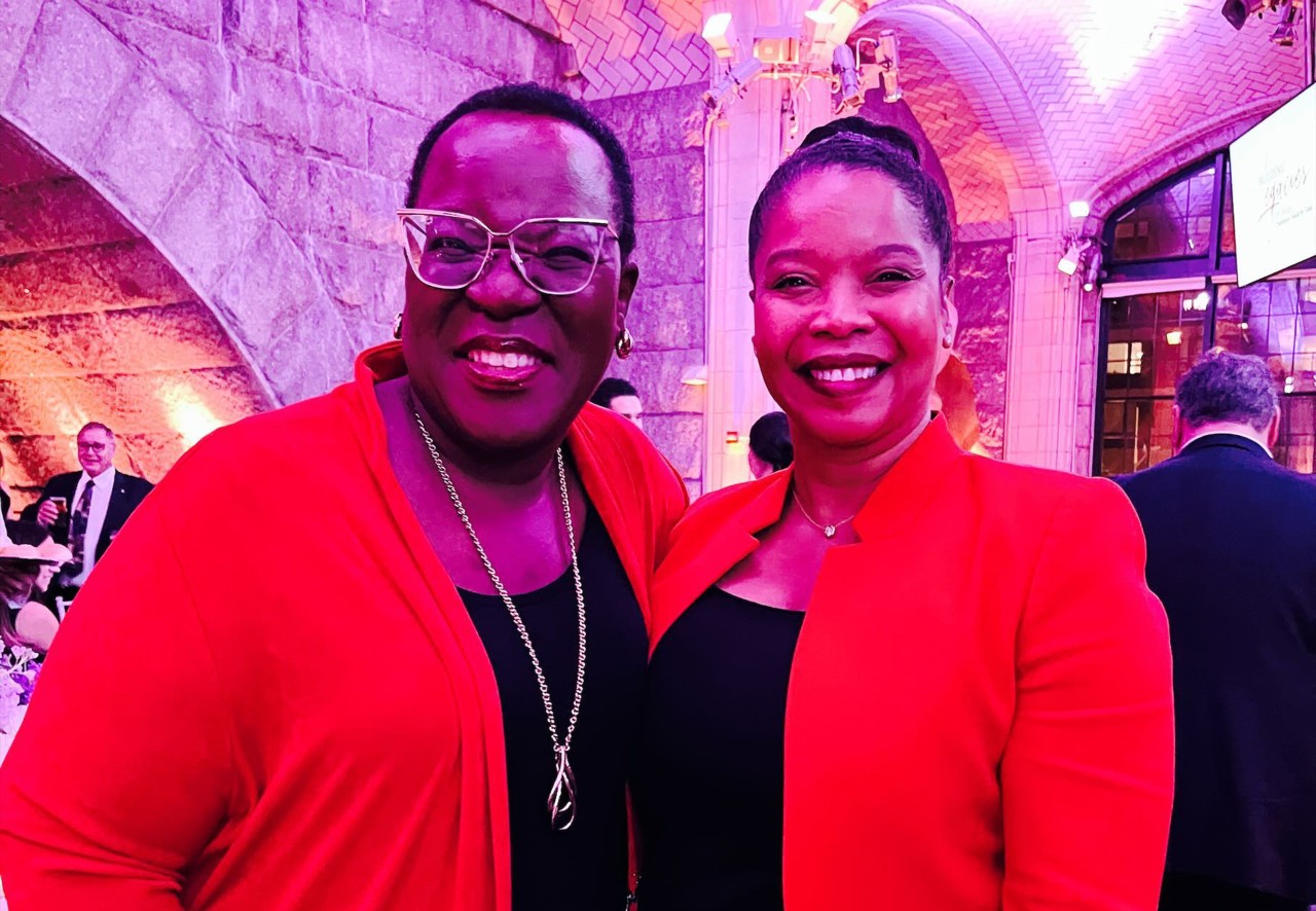 Two women smile at the camera