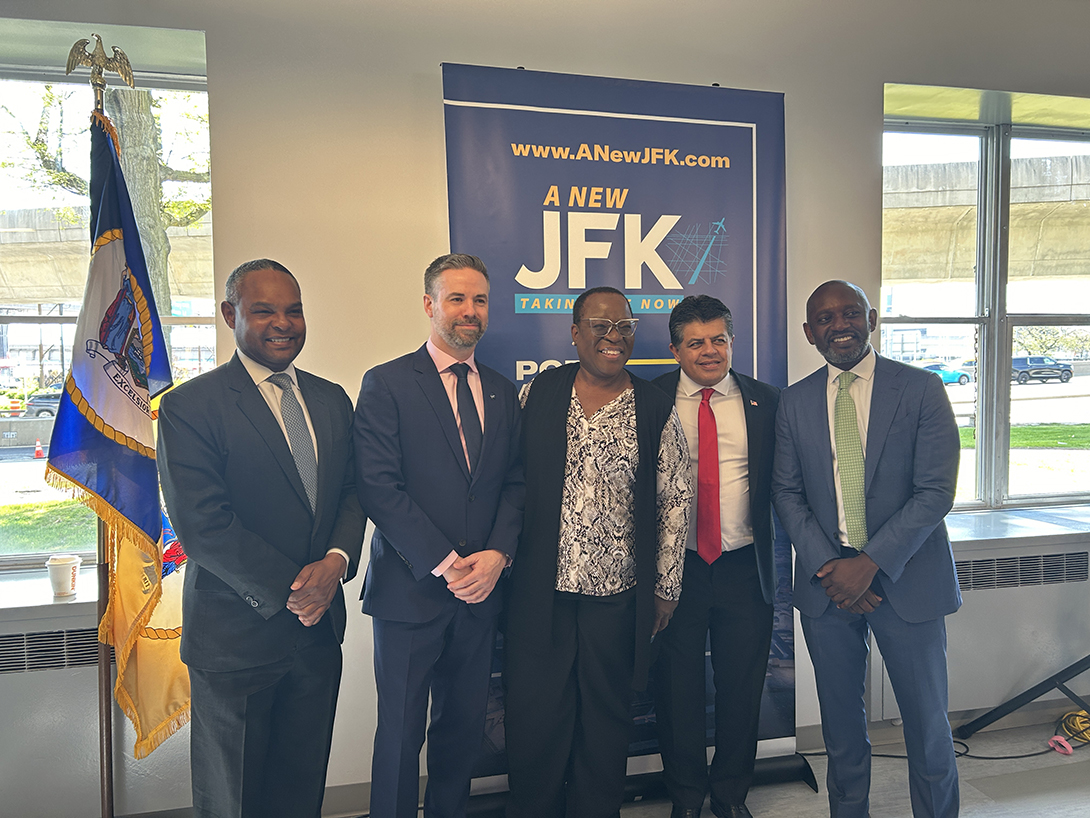 People stand in front of banner at business event