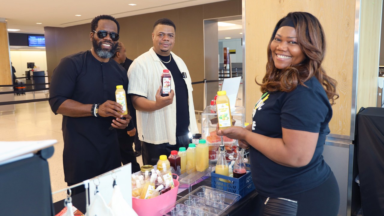 Three people show of juices at The Taste of Africa Popup