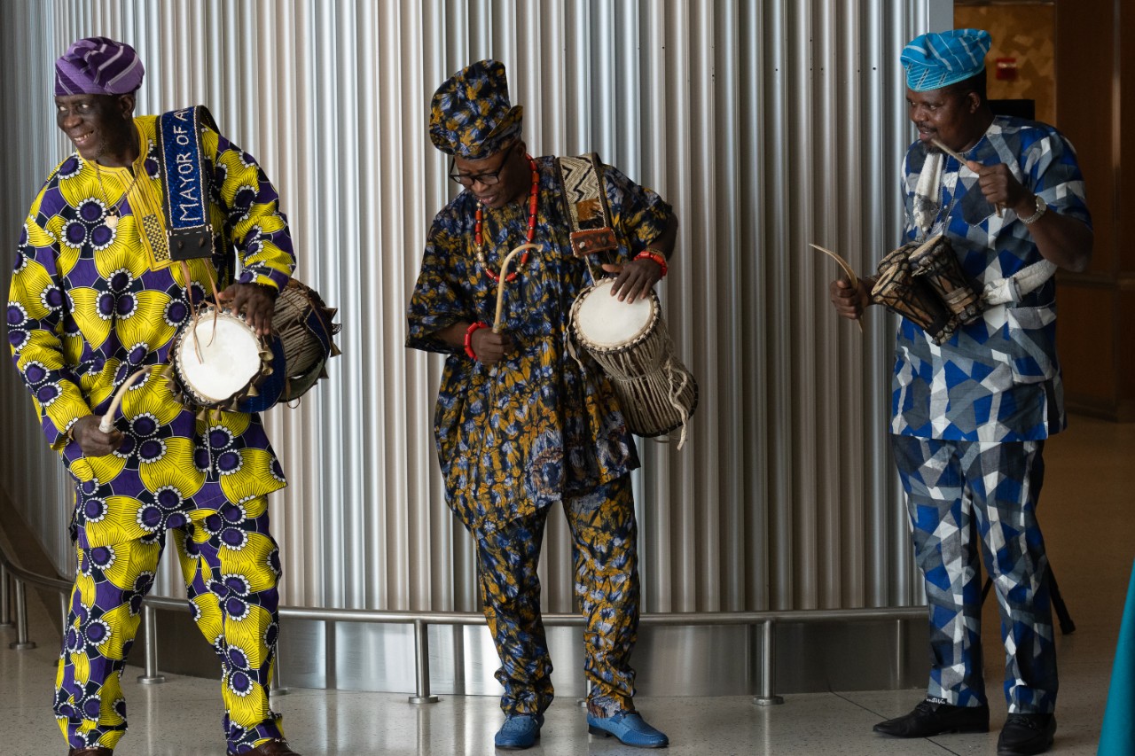 Performers with drums in traditional African clothing